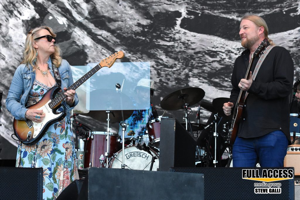 Two guitarists facing each other during a festival performance