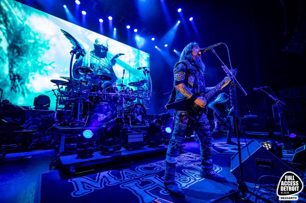 Wide view of a metal band performing under blue lights at the Fillmore