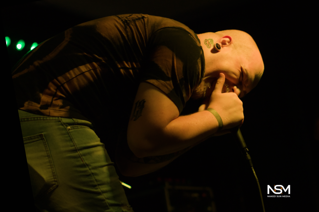 Vocalist leaning into a handheld microphone