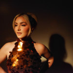 Maggie Rose in a gold sequined halter top, photographed for her Half Moon album release