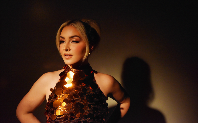 Maggie Rose in a gold sequined halter top, photographed for her Half Moon album release