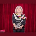 Bette Midler holds the 2026 Woody Guthrie Prize at Cain’s Ballroom in Tulsa.