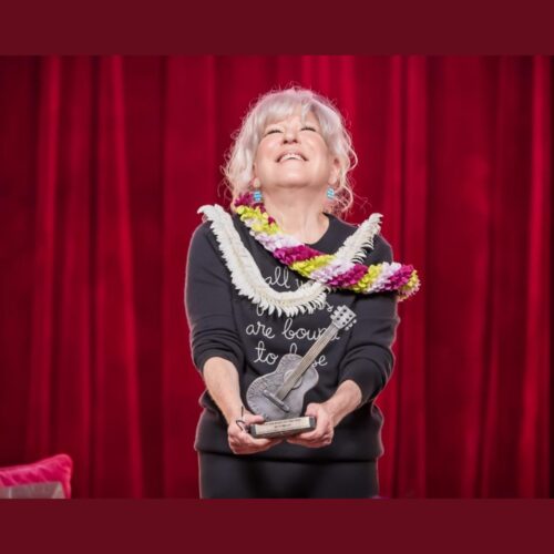 Bette Midler holds the 2026 Woody Guthrie Prize at Cain’s Ballroom in Tulsa.