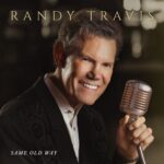 Randy Travis holding a vintage microphone on the Same Old Way album cover.